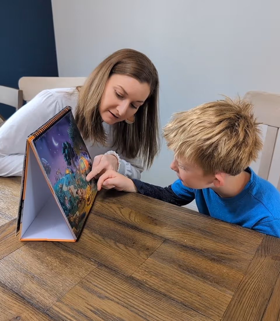 Rachel pointing to picture with child